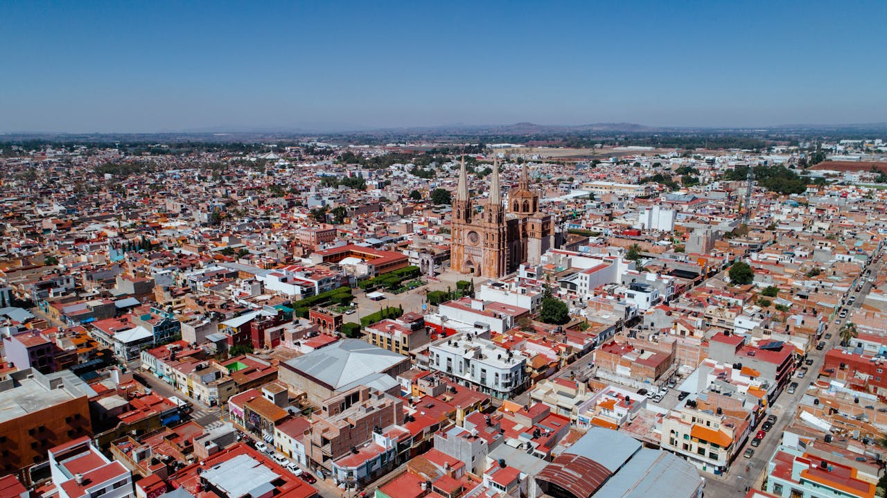 gallery-05 A stunning aerial view showcasing a historic cathedral amidst the vibrant cityscape in Mexico.