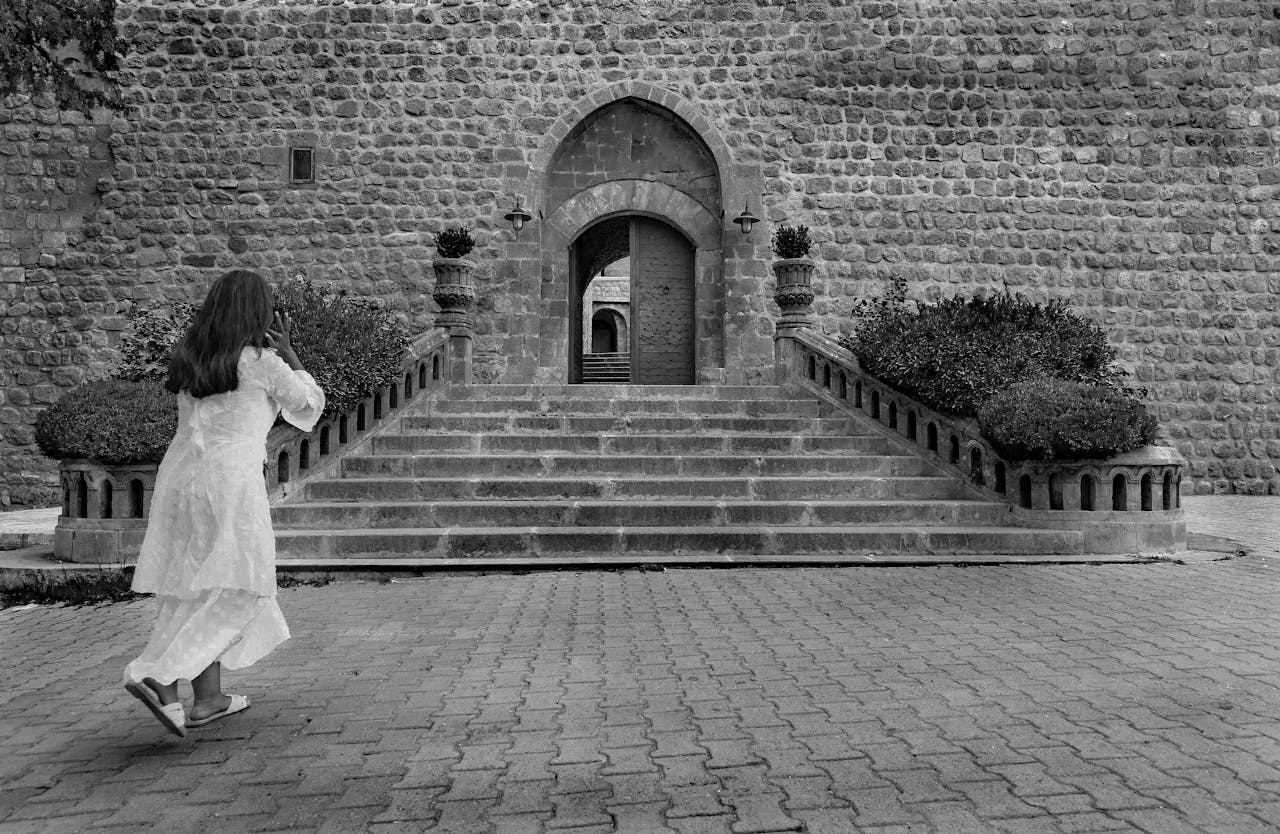 contact-img historical-stone-entrance-with-woman-in-motion-32576198